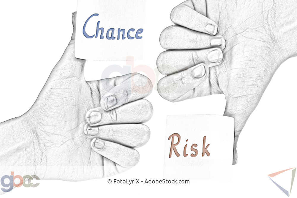 Hand with thumbs up with sticky note "Chance" and hand with thumbs down with sticky note "Risk".
